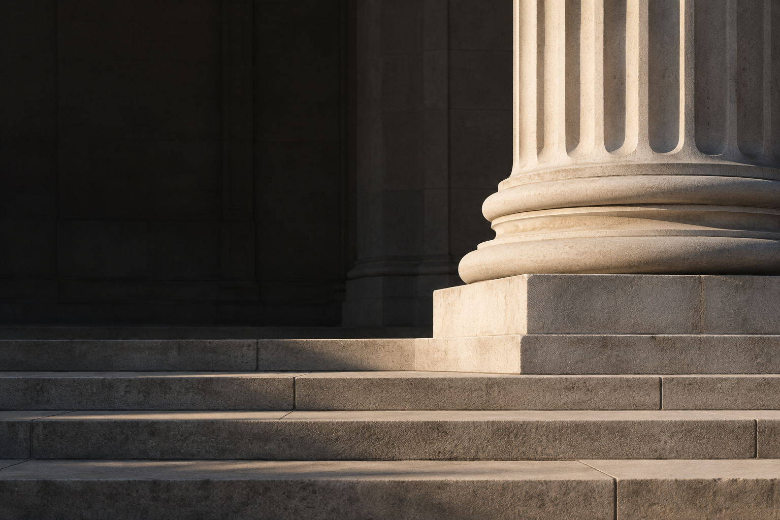 Limestone column and broad stone steps in dramatic natural light